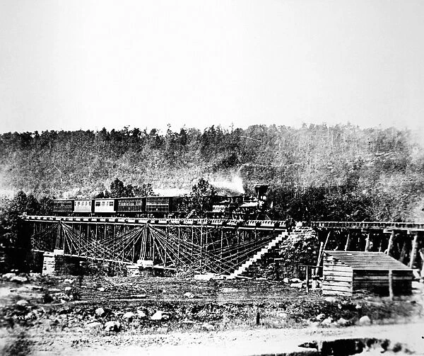 RAILROAD BRIDGE, 1858. A Baltimore and Ohio special train on one of the old Bollman