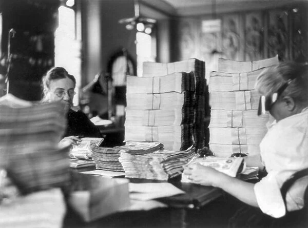 U. S. TREASURY, c1907. Two employees count stacks of paper money. Photograph, c1907
