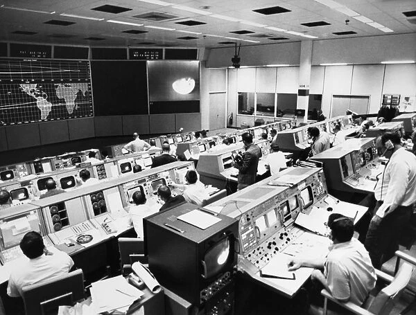 View of the Mission Operations Control Room at the Manned Spacecraft Center in Houston, Texas, on the third day of the Apollo 8 lunar orbit mission. On the television monitor is a picture of the earth telecast from the spacecraft. Photograph, 23 December 1968