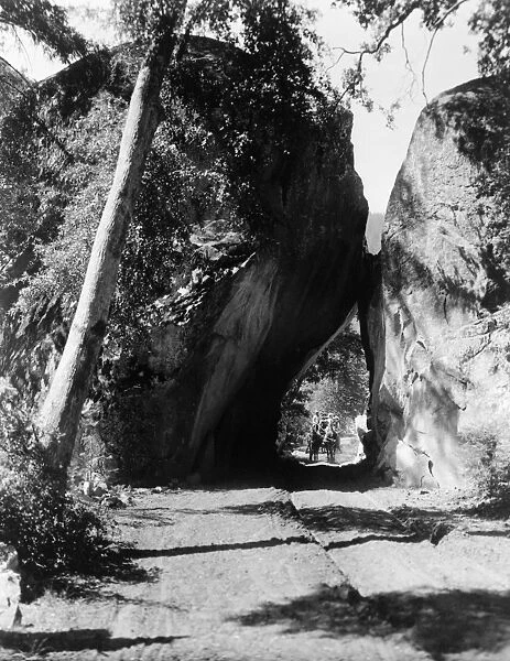YOSEMITE: ARCH ROCK, c1913. A horse drawn carriage traveling through Arch Rock