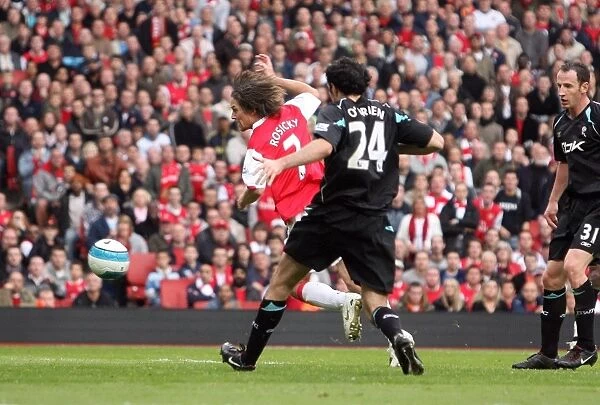 Tomas Rosicky scores Arsenals 2nd goal under pressure from Joey O Brien (Bolton)