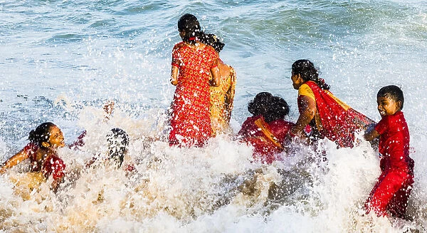 Children playing in the surf at Mamallapuram in Tamil Nadu, India
