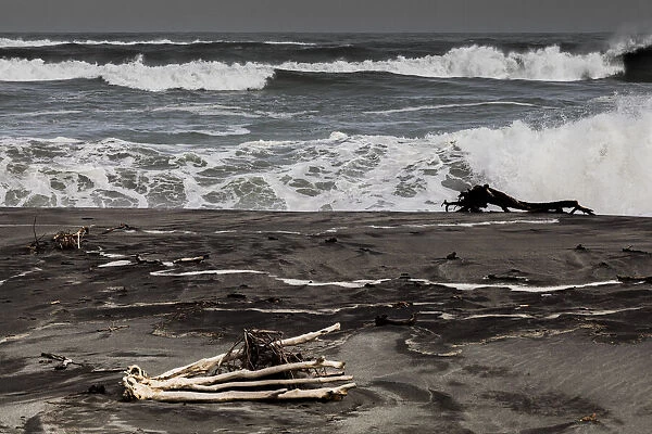 Logs washed up on the beach at Hokitika in West Coast, New Zealand