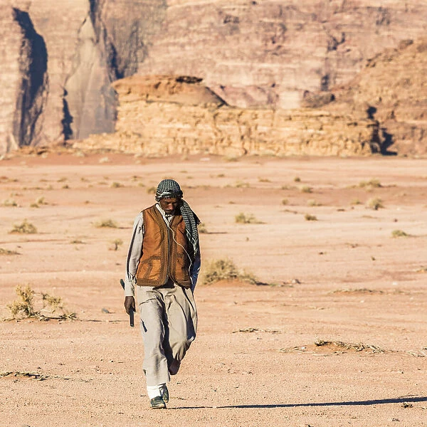 A man walking through the desert at Wadi Rum, Jordan