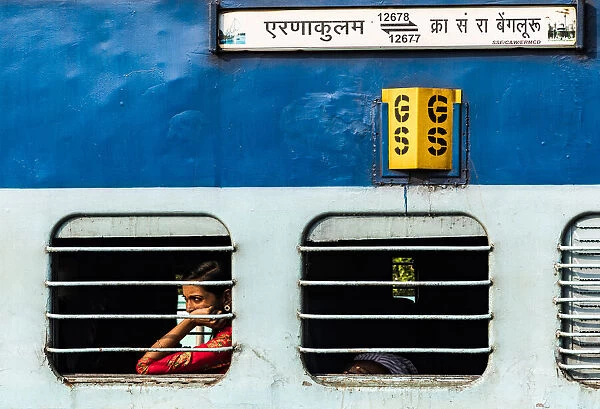 A passenger on an Indian Railways carriage. This is at Kochi in Kerala, India