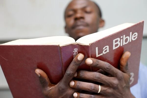 African man reading the bible