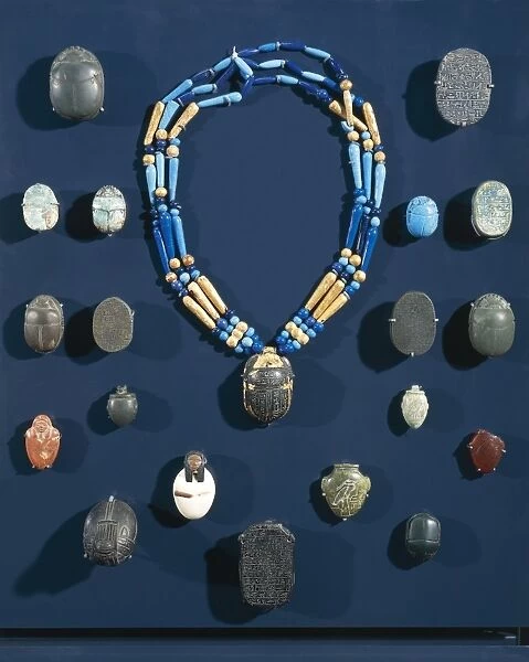 Ancient Egyptian ornaments and protective objects of the mummy: necklace and scarabs