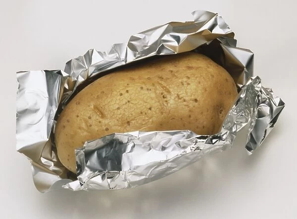 Baked potato in foil and in paper towel