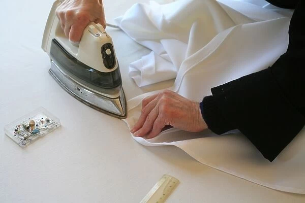Benedictine nun making religious vestment