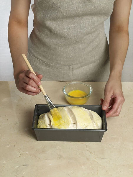 Brushing egg onto bread loaf (making gluten-free bread)