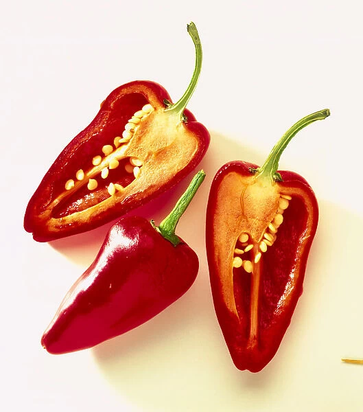 Capsicum annuum, a whole red pepper between two halves