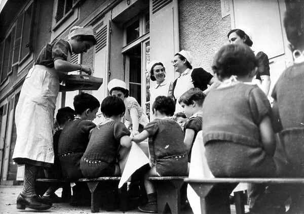Children at home run by the German Ministry of Health being served a meal outside