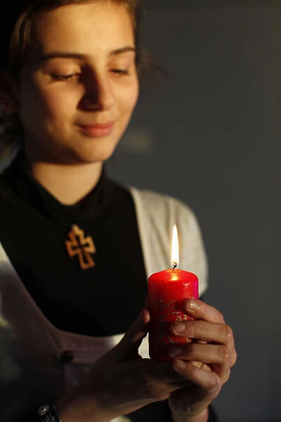 Christian girl holding a Christmas candle