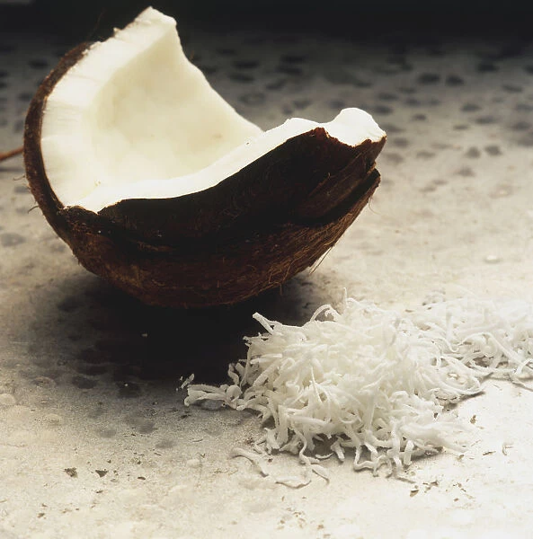 Cocos nucifera, Coconut, cracked shell containing milk, and grated white flesh