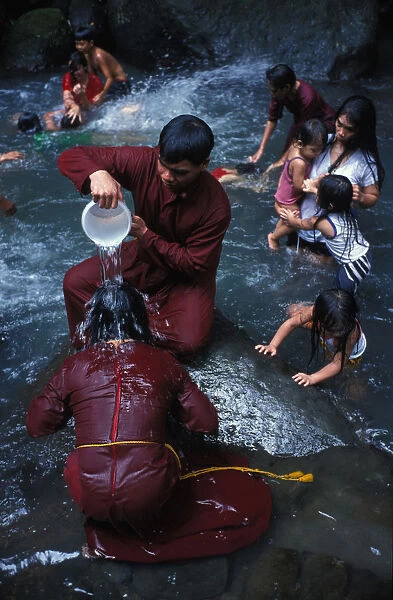 Filipino pilgrim bathing in Santa Lucia holy water at the foot of Mount Banahaw during Lent