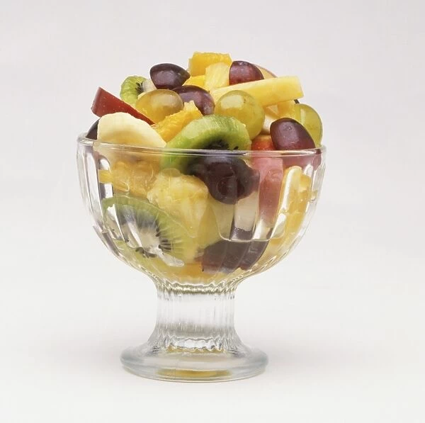 Fruit salad served in glass bowl, close up