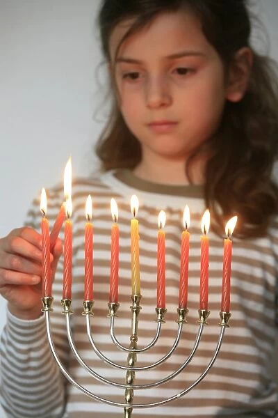 Girl lighting Hannuka candles
