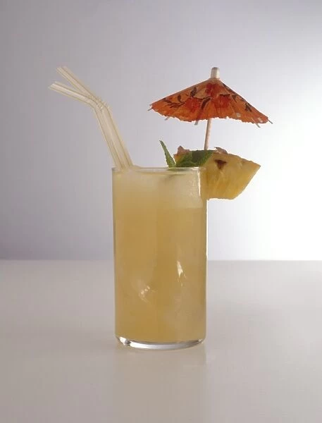 Glass of Sunset Strip, a Californian cocktail with cocktail umbrella, pineapple garnish and drinking straws