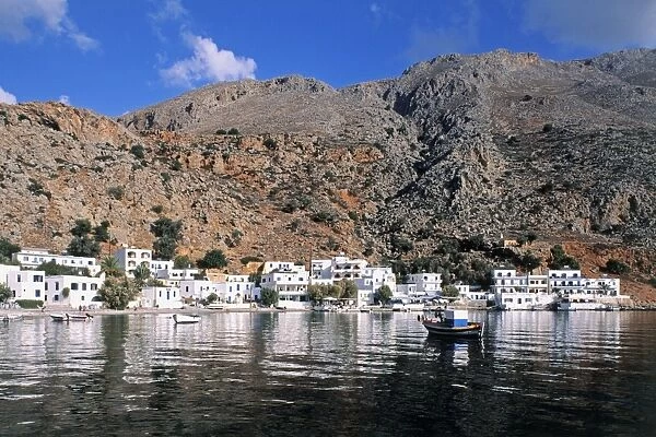 Greece, Rethymno, tranquil bay and whitewashed houses of Loutro, nestling beneath rugged hills