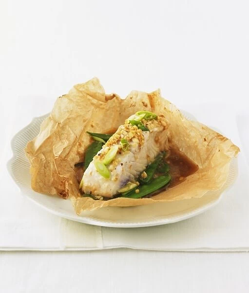 Halibut in paper with mangetouts, spring onions, nuts and sauce