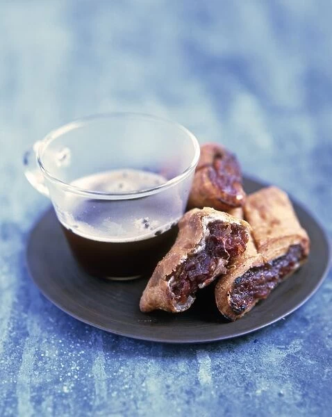 Imqaret, Maltese date pastries served with cup of coffee, on a plate