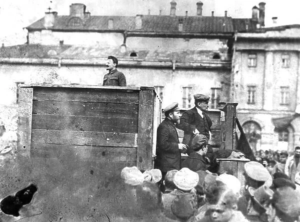 Leon trotsky addressing troops on their way to the polish front (civil war period), may 5th 1920, sverdlov square, moscow, on the stairs behind the speakers platform are lev kamenev (in peaked cap) and v, i, lenin