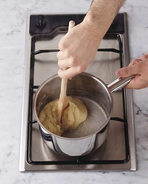 Mixing choux pastry in pan on hob, close-up