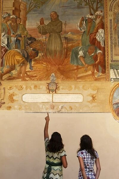 Mother and daughter looking at a fresco