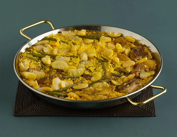 Paella Valenciana in pan, containing beans, chicken, rice, saffron