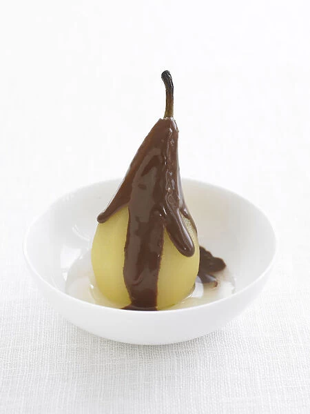 Pears Helene, poached pears with rich chocolate sauce, close-up