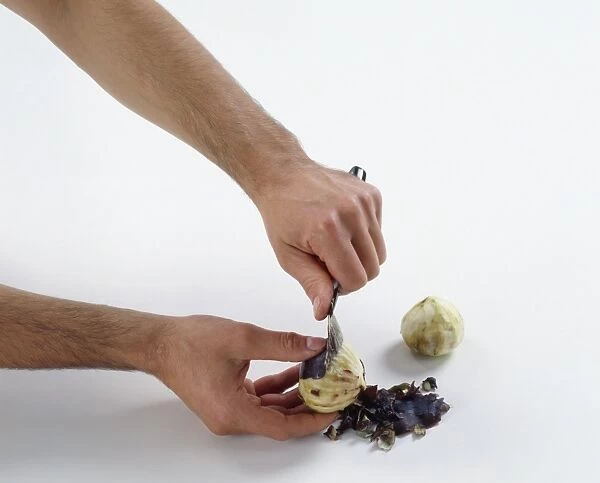Peeling skin away from a fig using a knife
