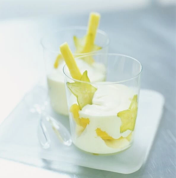 Pineapple zabaglione served with whipped cream and tropical fruit slices, close up