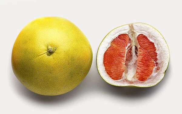Pomelo fruit, whole and sliced in half