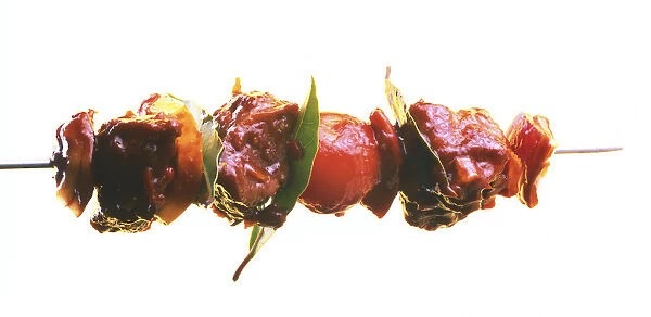 Pork and vegetable skewer dipped in an orange and ginger sauce