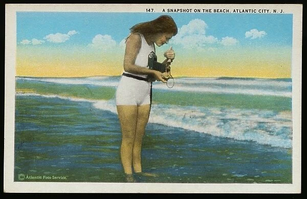 Postcard of a Woman Photographing the Ocean. ca. 1921, 147 A Snapshot on the Beach, Atlantic City, N. J. Published by Saltzburgs Merchandise Co. Atlantic City, N. J