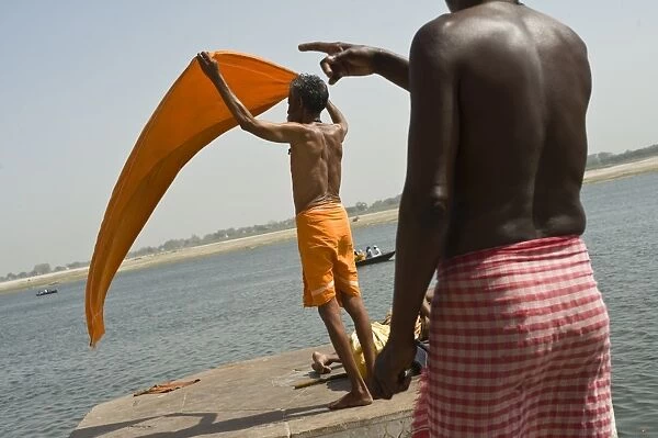 Sadhu drying his sari in the wind by the Ganga River