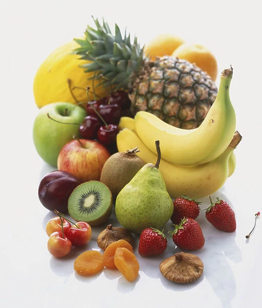 Selection of fresh fruit, pineapples, bananas, cherries, figs, strawberries, melons, peaches, pears, kiwis, plums