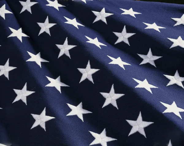 These are the stars of the American flag. They are against their blue field, climbing upward toward the corner of the image as if they were situated on small stairs that move up in levels