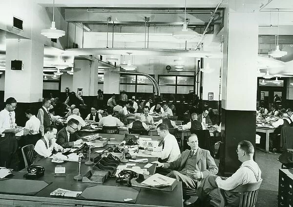Sub-editors in a newspaper news room. Circa 1945