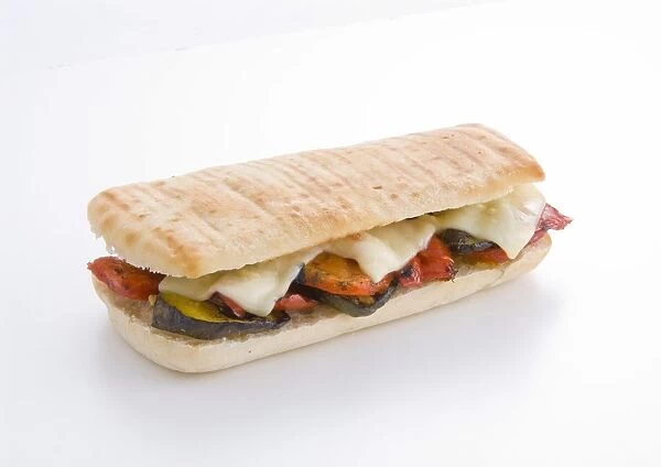 Toasted ciabatta sandwich stuffed with sliced aubergines, tomatoes, melted cheese, close-up