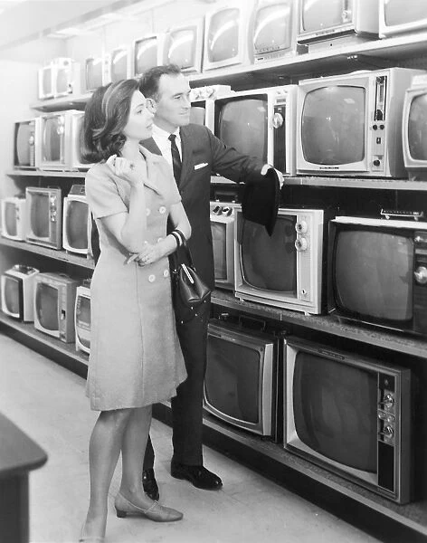 Vintage couple shopping for a television