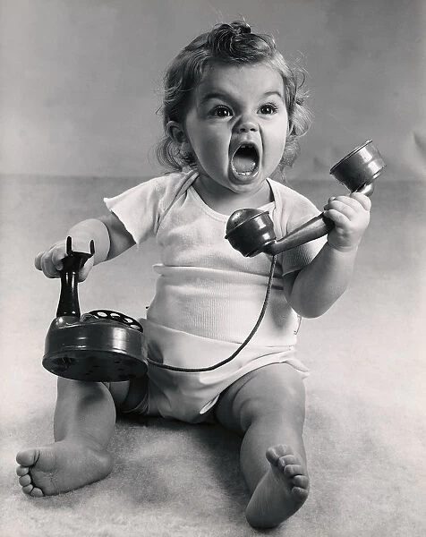 Vintage photo of infant screaming with phone