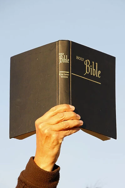 Woman holding up a Bible