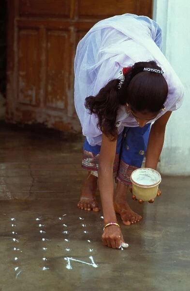 Woman making ritual marks on her doorstep