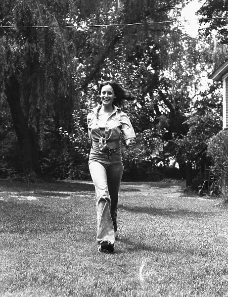 Young woman walking in the grass