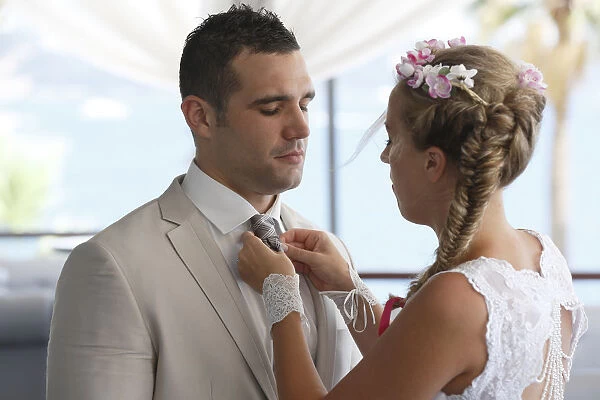 Bride adjusting the grooms tie