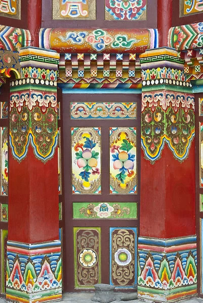 Colorful Tibetan designs on wall and columns of temple, Jiuzhaigou National Scenic Area, Sichuan Province, China