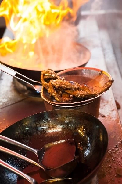 Fish deep-fried in asian wok on the street food stall, Penang, Malaysia