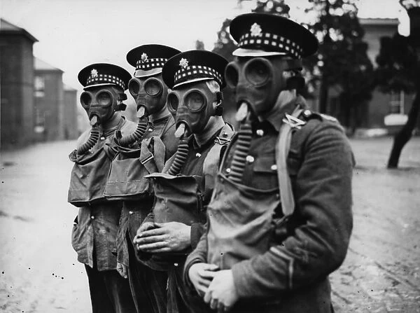 Gas Masks. 7th April 1927: Scots Guards trying on their gas masks before sailing to China