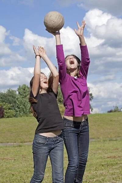 Two girls playing wth ball